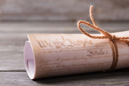 Close-up tied scroll. Wooden desk background.