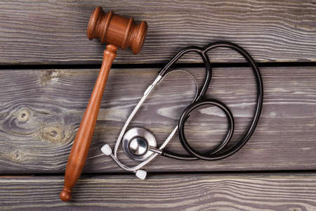 Gavel and stethoscope on wood. Medicine and court concept.の写真素材