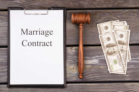 Marriage contract and corruption concept. Top view flat lay. Old wood desk background.の写真素材