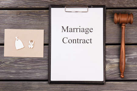 Marriage contract and wooden gavel on the desk. Clipboard with marriage contract.の写真素材