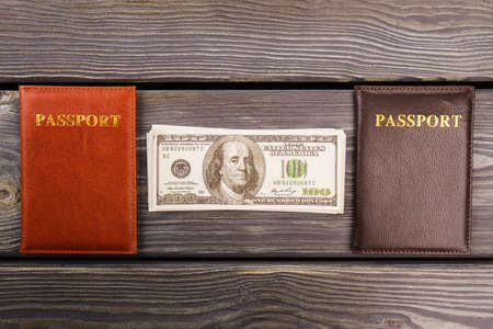 Flat lay passports and money. Grey desk background.