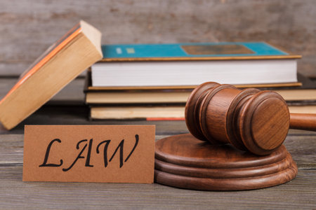 Justice and law concept. Wooden gavel and stack of books.の写真素材