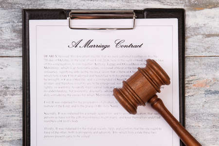 Gavel and marriage contract. Clipboard with page.の写真素材