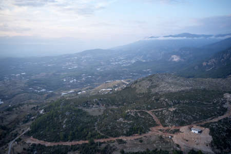Mountain village on a cloudy day. Aerial view of hiking trails in the mountains. Picturesque morning...