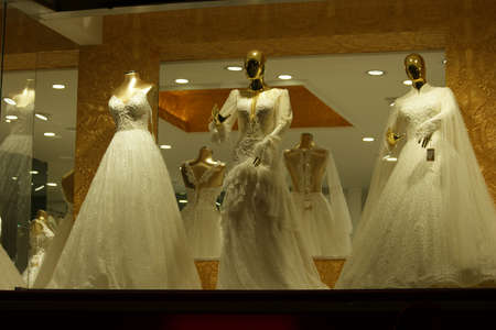 Fashion boutique store with wedding dresses for wedding. Collection of wedding dresses in showcase of the shop. Interior of bridal salon.の写真素材