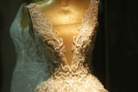 Close up of wedding dress with floral embroidery. Mannequin dressed in beautiful wedding dress....