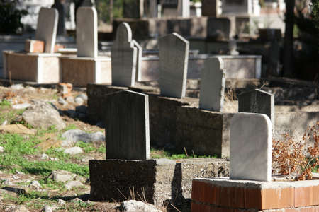 Tombstone and graves in an ancient Muslim graveyard. Islamic headstones and memorials in Turkish...