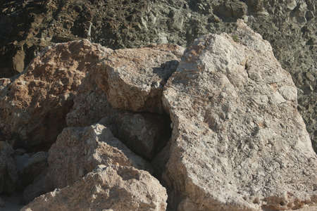 Large rocky mountains close up. Big relief stone cliffs on a summer day. Geology concept.