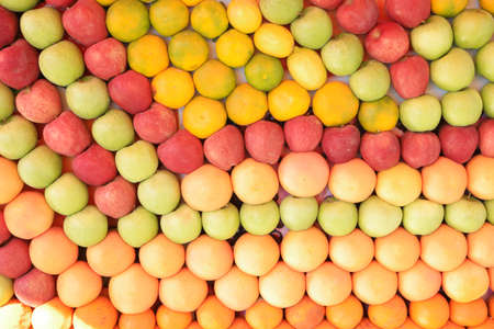Assortment of fresh and natural fruits sorted by color. Assorted fruits texture. Food background.の写真素材