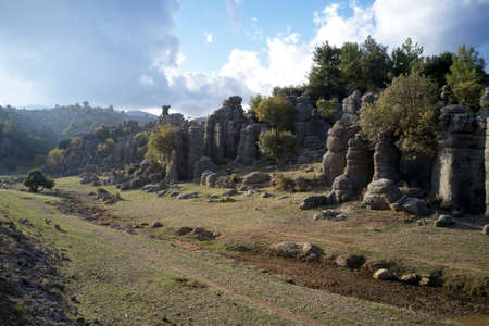 Beautiful green valley with rock formation on a summer day.