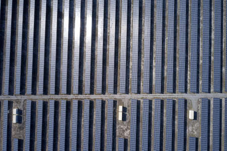 Top view of blue solar panels on a sunny day.