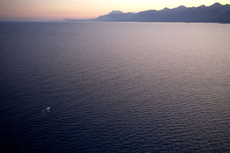 Seascape with a view of a mountains at sunset.の写真素材