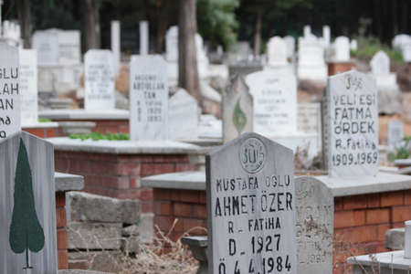 Grey headstone on grave at Muslim cemetery.