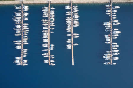 Aerial view of luxury yachts anchored in harbour.