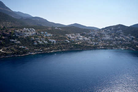Aerial view of coastal town and mountains.