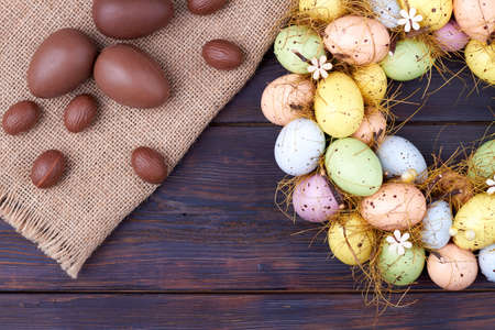 Composition of natural and chocolate easter eggs.