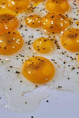 Collection of egg yolks covered with decorative sparkles.の写真素材
