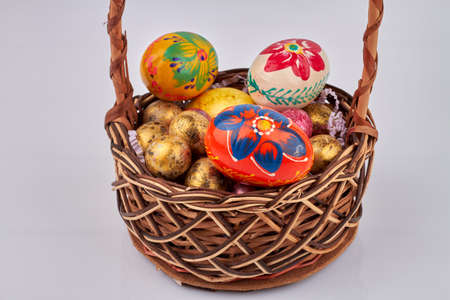 Decorated easter eggs in a wicker basket.