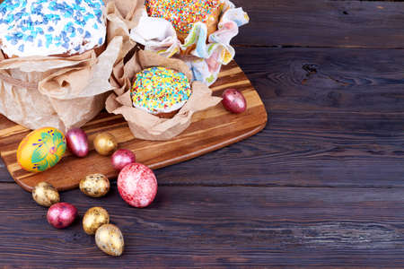 Easter cakes and eggs on wooden table.の写真素材