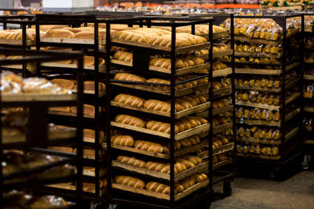 Rack trolley with freshly baked bread at supermarket.