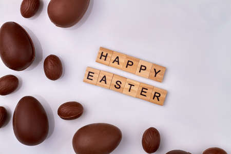 Happy easter wish and chocolate eggs.の写真素材