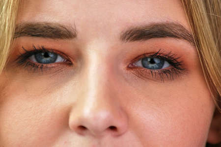 Young girl face with blue eyes and long eyelashes.の写真素材
