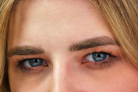 Close up blue eyes of an attractive blond girl.の写真素材