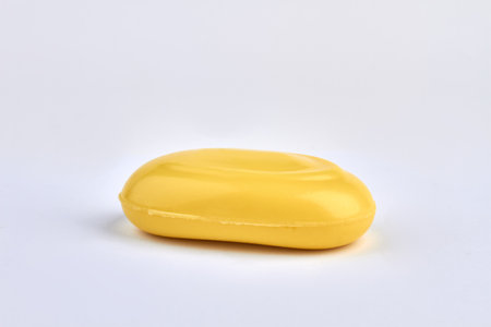 Bar of yellow soap isolated on white background.
