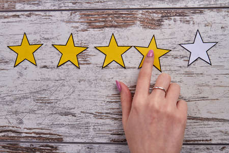 Female hand giving a rating.の写真素材