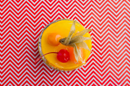 Top view of sweet yellow cake with fruits topping.の写真素材