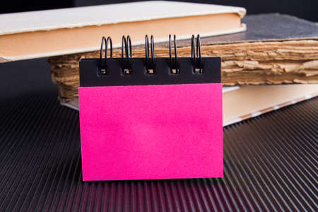 Blank pink page of a paper note book with space for text.