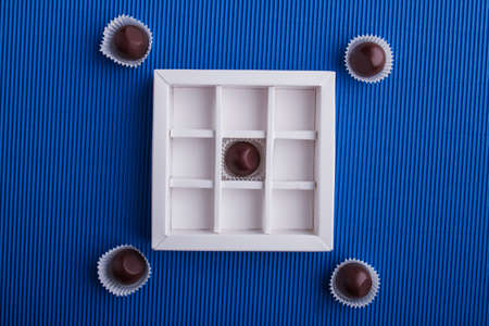 Flat lay composition of dark chocolaes with the box.の写真素材