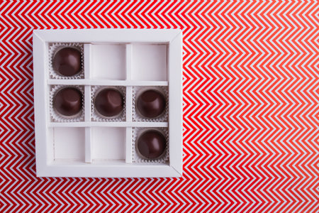 White square box with round chocolate candies.の写真素材