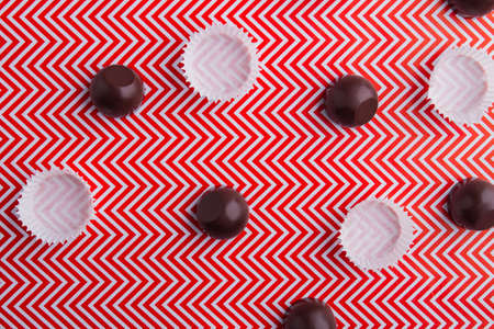 Top view flat lay chocolate candies and wraps.