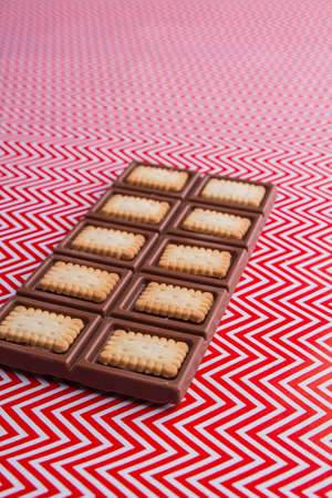 Vertical shot of delicious chocolate bar with crunchy cookies angle view.