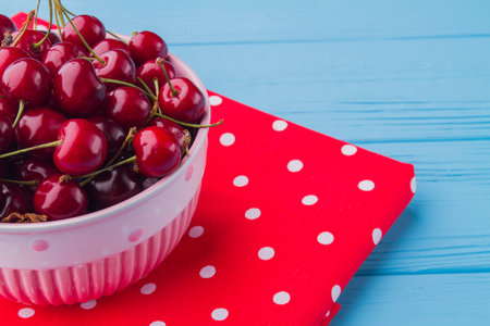 Close-up pile of red fresh cherries in a bowl.の写真素材