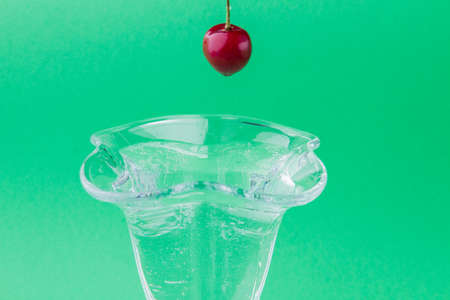 Raw fresh cherry over glass dish tulip for ice cream.