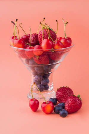 Vertical shot of glass cup full of fresh ripe fruits.の写真素材