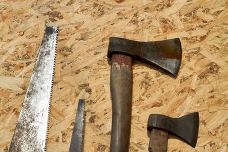 Set of mens work tools on plywood top view.