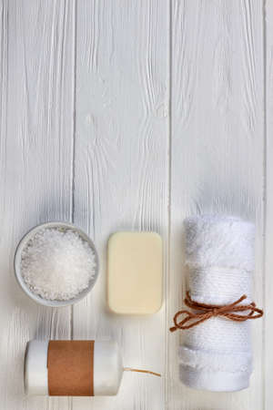 Set of spa accessories on white wooden desk.