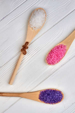 Three rustic wooden spoons with crystal salt minerals.の写真素材
