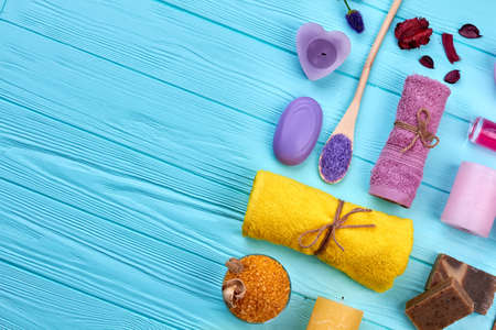 Bath and spa stuff on blue wooden table top view flat lay.