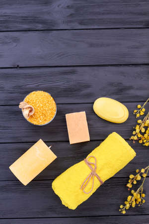 Vertical shot yellow bathroom stuff on black wood.の写真素材