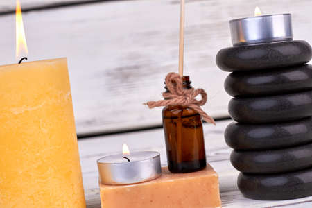 Spa setting of bodycare accessories on wooden background.