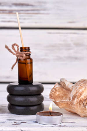Bottle of oil with stones and seashell for spa therapy.の写真素材