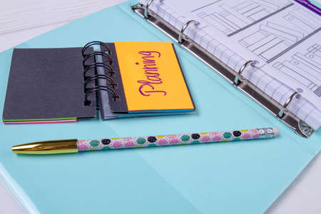 Planning calendar and pen on blue sheet.