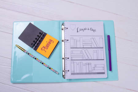 Top view folder with notepad and pencil.