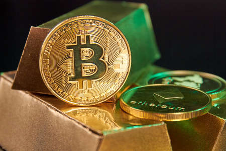 Cryptocurreny coins on the bunch of golden ingots.の写真素材