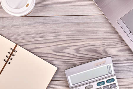 Calculator with blank notepad and copy space. White wood background.の写真素材