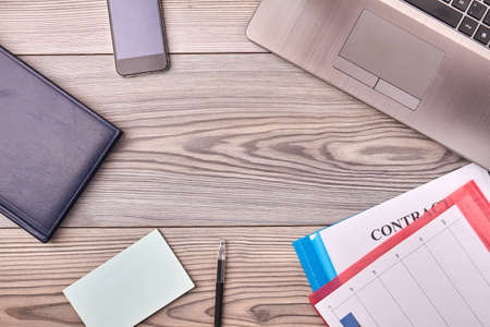 Top view flat lay office work desk and copy space. Laptop pc with pen and smartphone.